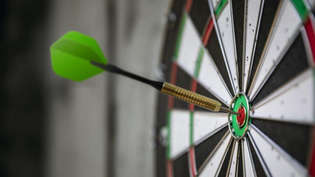 a typical darts game with dart in the bullseye