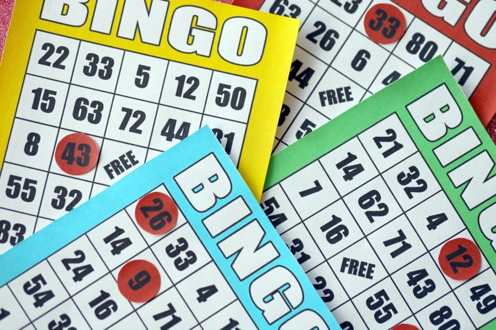 Many colorful bingo boards or playing cards for winning chips